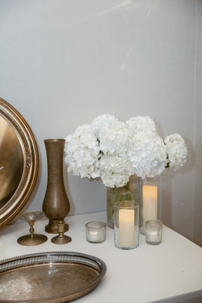 Simple floral arrangement with candles as part of the table decor.