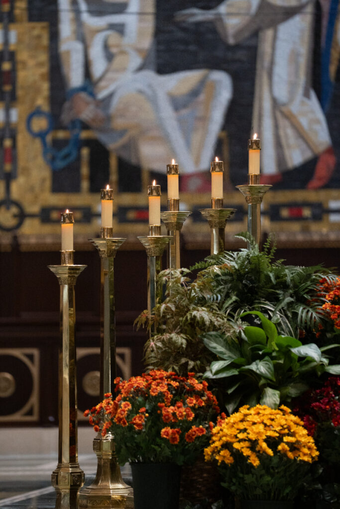 церemоny altar with candles and florals inside St. Peter in Chains Basilica during a Hilton Netherland Plaza wedding.