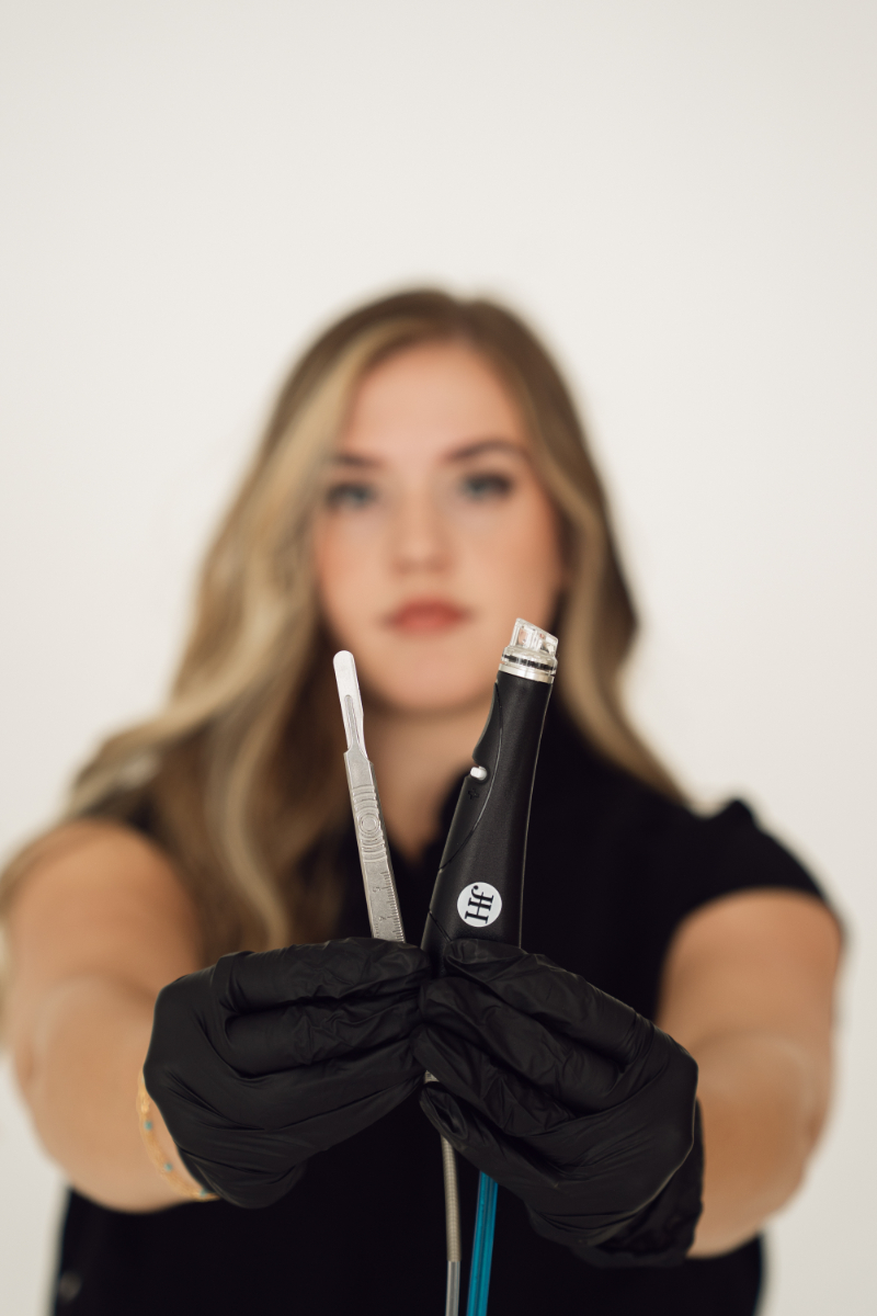 Close-up of a professional holding skincare tools with gloved hands, clean studio background and soft focus portrait