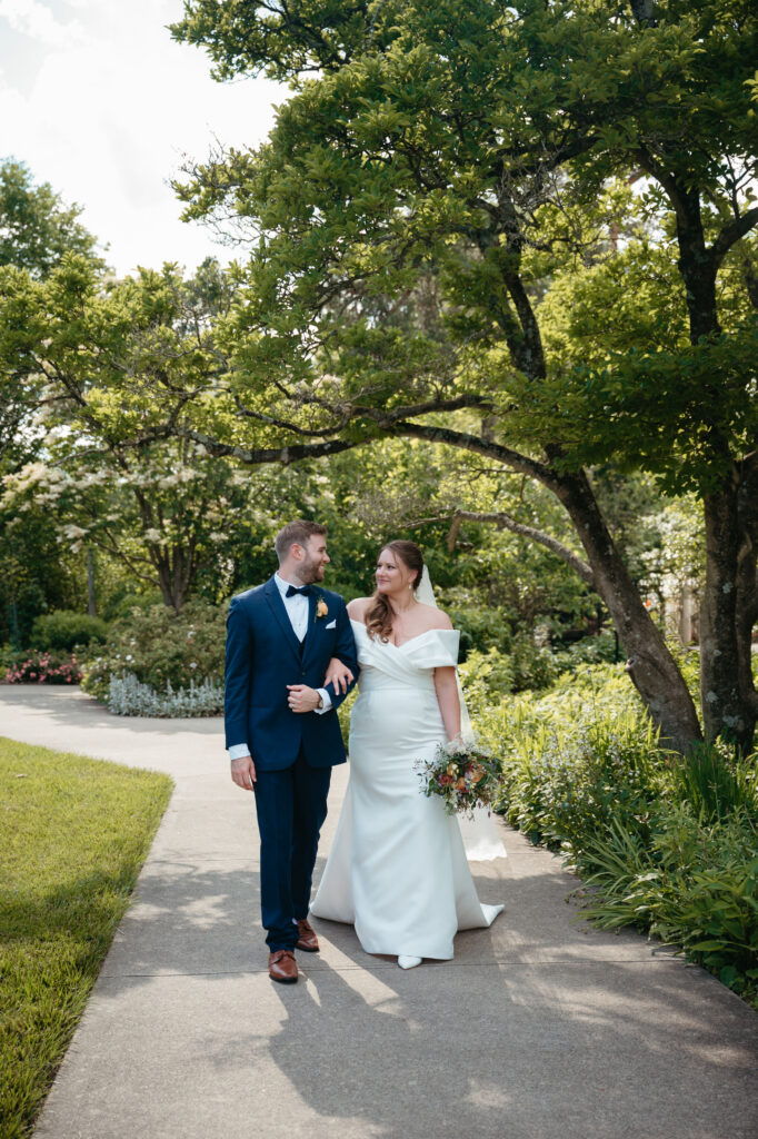 Bride and groom walk through the gardens at one of Cincinnati's beautiful garden wedding venues.