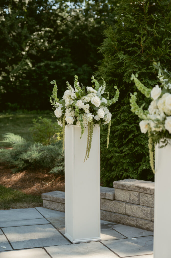 White ceremony flowers at The Palomar create a timeless backdrop at one of our favorite Ohio wedding venues.