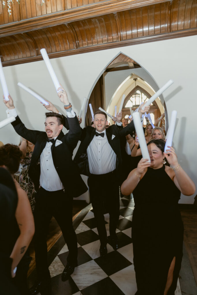 Wedding guests cheer during the lively reception entrance at The Palomar, one of Ohio wedding venues.